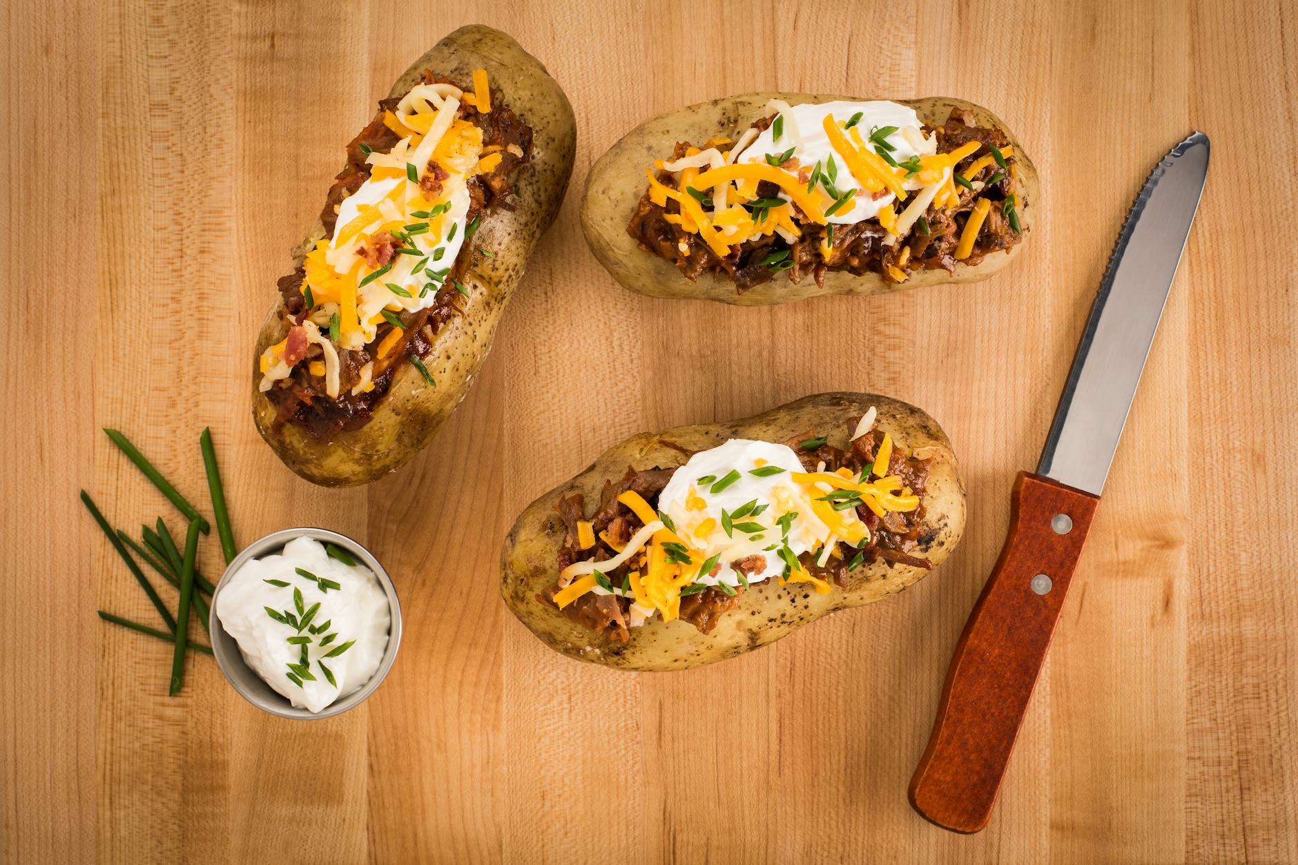 Fully Loaded Baked Potatoes with Cheddar, Bacon, and Scallions