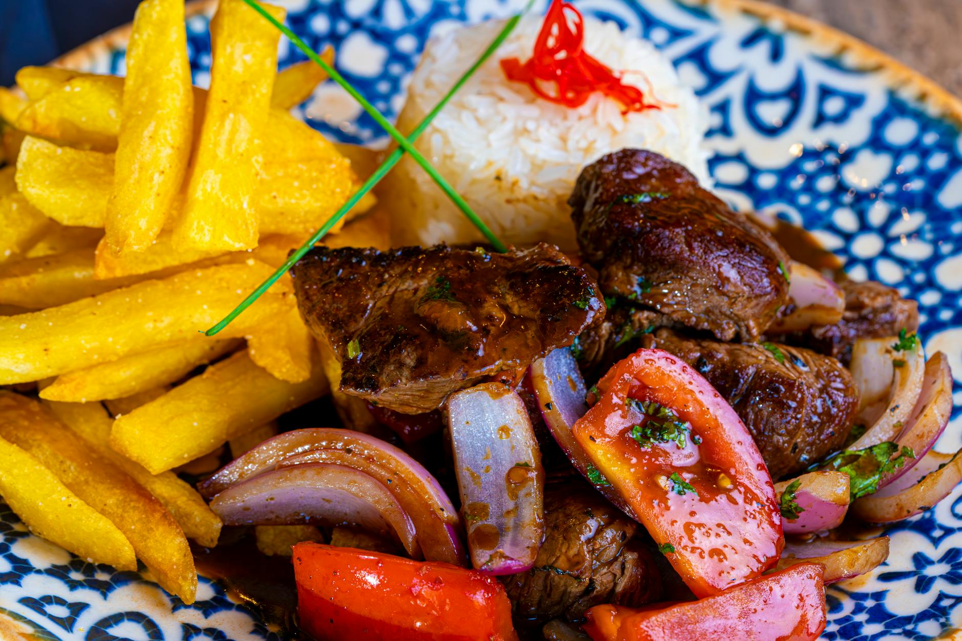 Peruvian Lomo Saltado with Red Onion, Tomatoes, and Fries